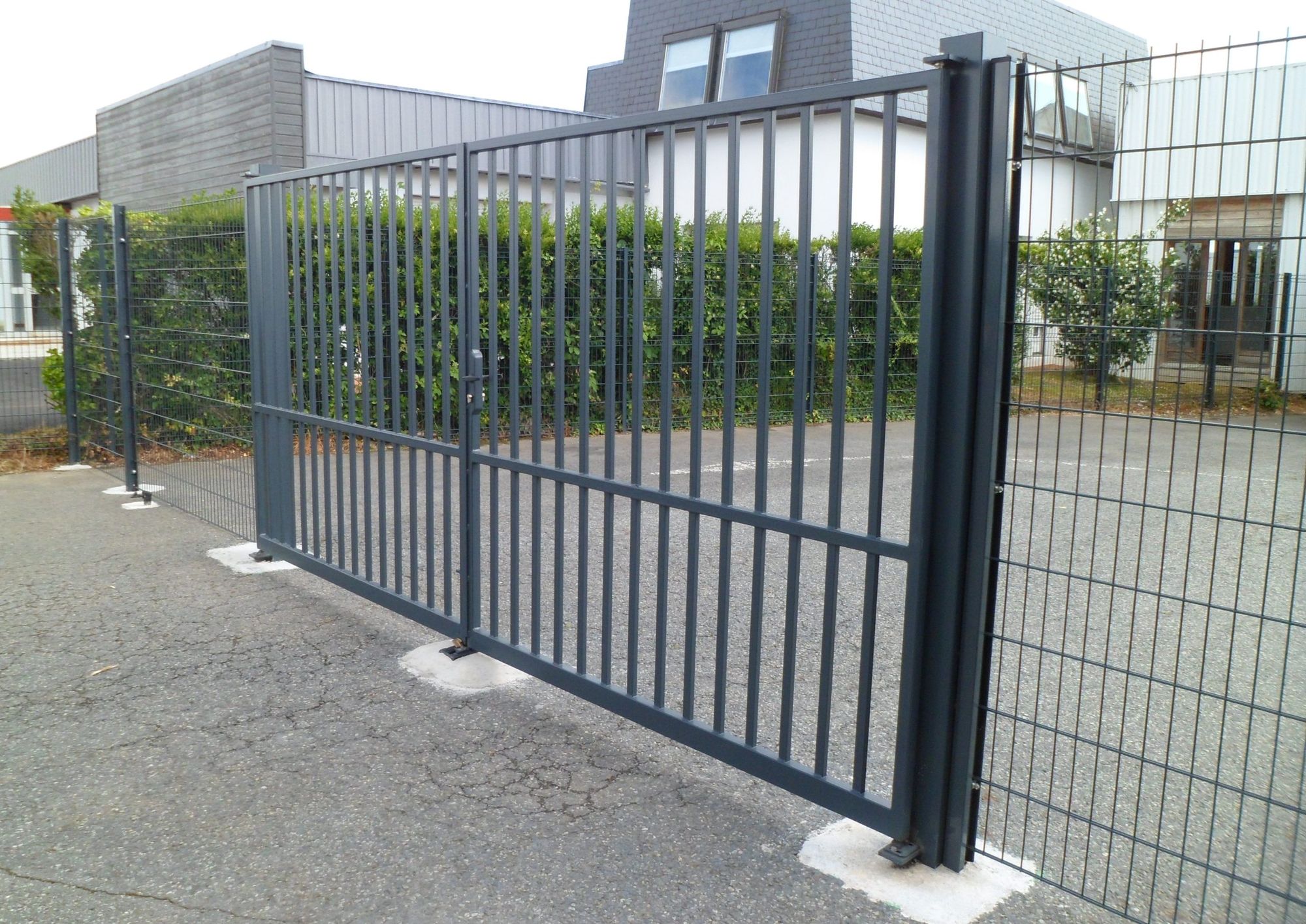 Portail coulissant en acier à barreaudage devant une maison